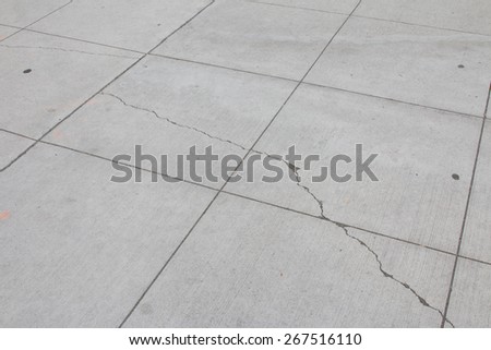 Small cracks on concrete sidewalk