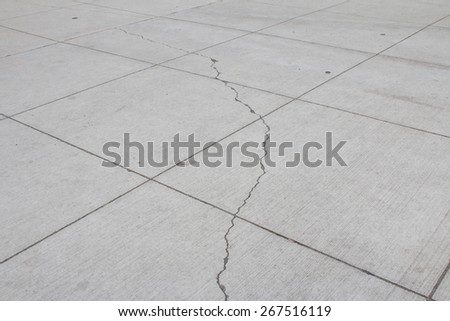 Small cracks on concrete sidewalk