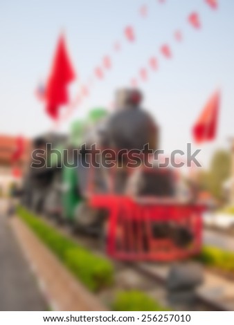 Natural bright blurred background of old train monument.