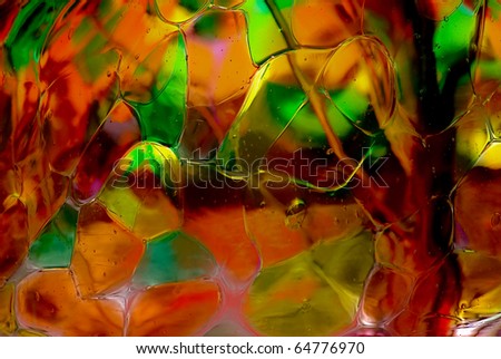 image of a multi colored glass ball with green, orange yellow colors.