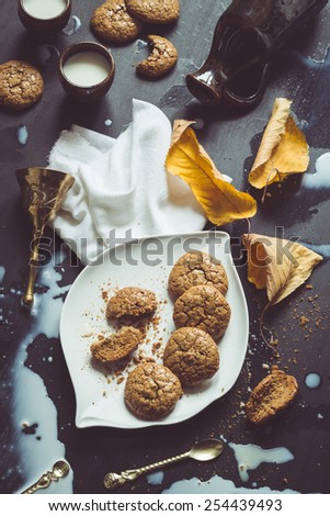 Retro Filtered Image: Flourless Walnut Cookies, Milk and Cherry Leaves Messy Still Life