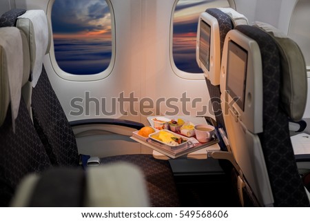 Food served on board of economy class airplane on the table.