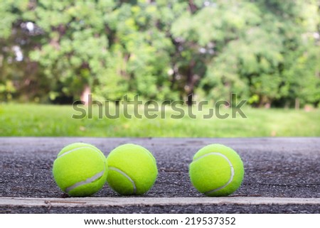 Three of Tennis ball on the ground