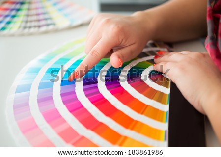 Graphic designer working with pantone palette in studio