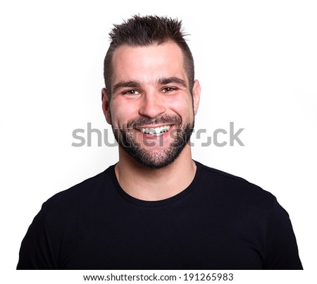 Young man in black t-shirt smiling on white background