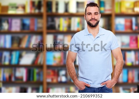 Young man in a blue polo shirt with a bookstore