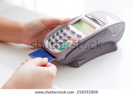 Woman pay by credit card in shop