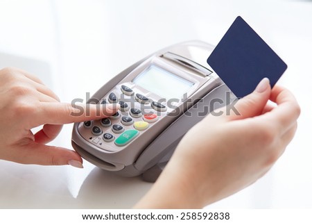 Woman pay by credit card in store