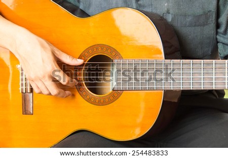 Acoustic guitar guitarist playing.Close up of guitarist hand playing acoustic guitar