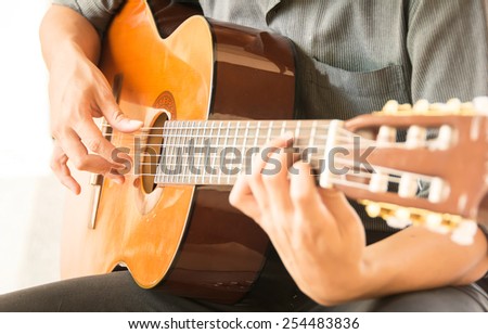 Acoustic guitar guitarist playing.Close up of guitarist hand playing acoustic guitar