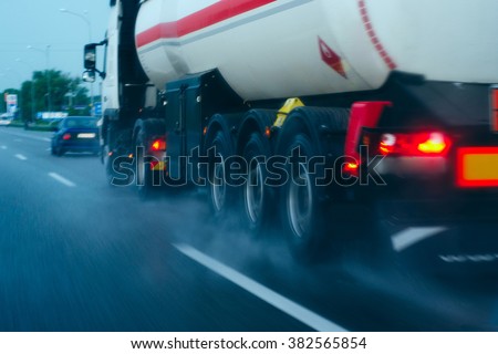 tanker on the move/tanker traveling on a wet road