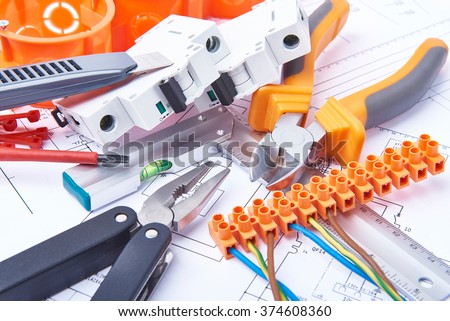 Components for use in electrical installations. Cut pliers, connectors, fuses, knife and wires. Accessories for engineering work, energy concept.