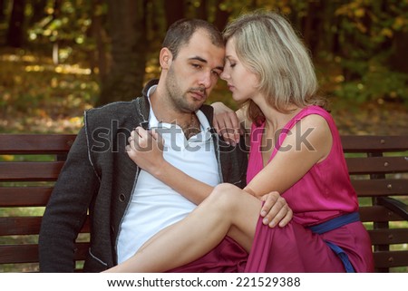 A young couple is sad sitting on the bench