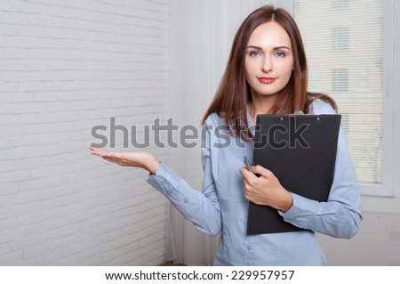 Girl in formal attire holding a folder expressing bewilderment