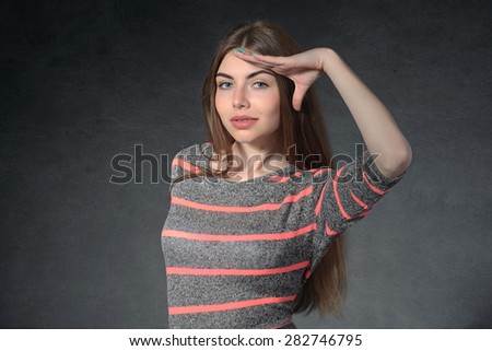 Concept human emotions. Girl shows curiosity against a dark background