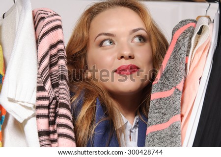 Woman in formal clothes excited buying things in a clothing store