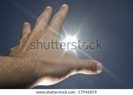 human hand, sun and blue sky