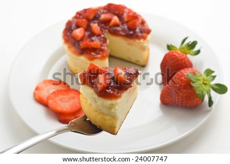 cheesecake with fresh strawberries and blackberry jam isolated over white