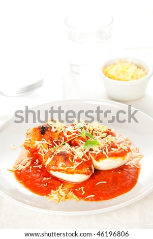 stuffed eggs with tomato and shredded cheese