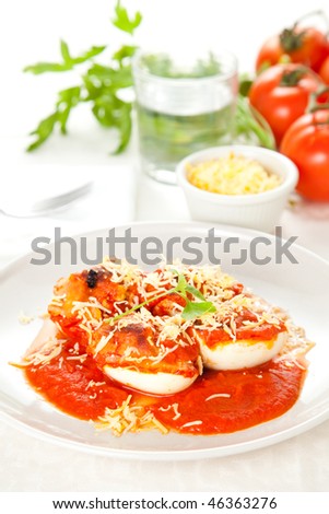 stuffed eggs with tomato and shredded cheese
