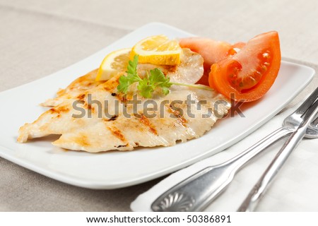filet grilled chicken with tomato and parsley