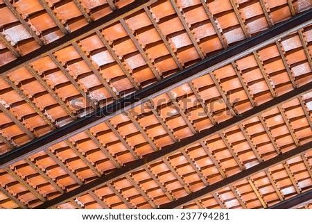 Baked Clay Roof tier on rusty iron bars