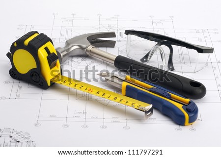 Various home tools on blueprint as home construction concept