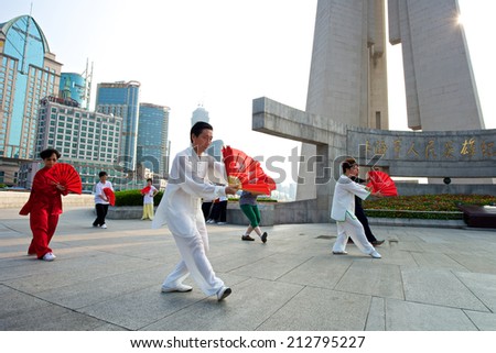 Shanghai, China - August 6, 2014: A beautiful view of Shanghai Skyline at sunrise with people doing Tai Chi.