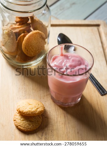 Oatmeal cookies. Oatmeal cookies in glass jar and glass yogurt  on wooden table