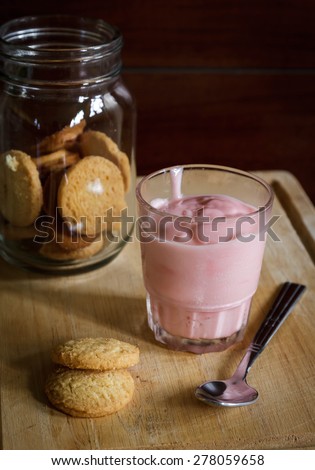 Oatmeal cookies. Oatmeal cookies in glass jar and glass yogurt  on wooden table