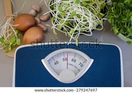 Bathroom Weight Scale and egg with  green young sunflower sprouts  diet food concept