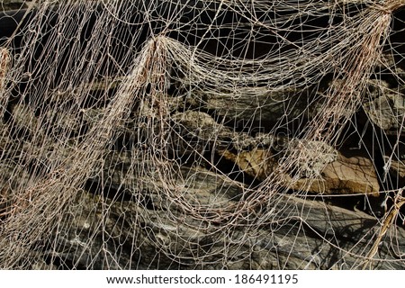 Fishing net on the old stone wall