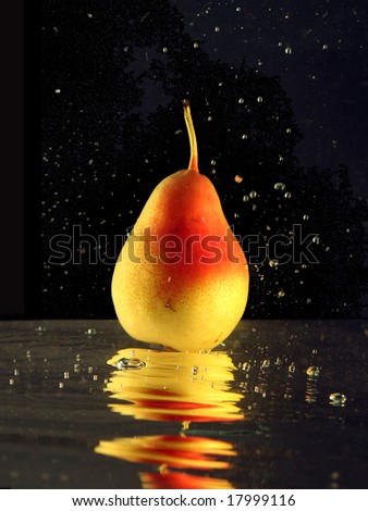 Fresh pear landing into water