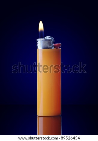 Lit orange lighter on dark blue background