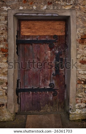 Ancient wooden door on pig-iron loops