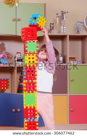 Child in a nursery built towers with blocks
