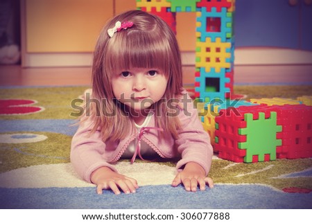 Child in a nursery built towers with blocks