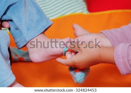 Brother and sister children\'s feet  in nursery