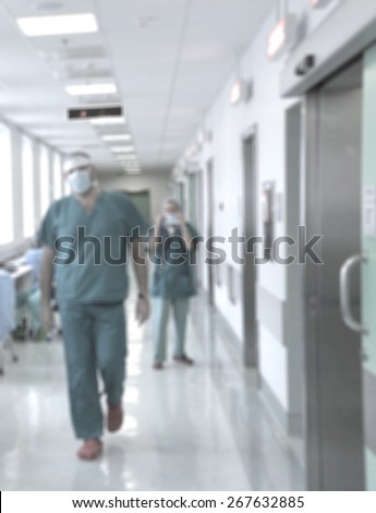 Blurred motion doctors and nurses walking in hospital corridor