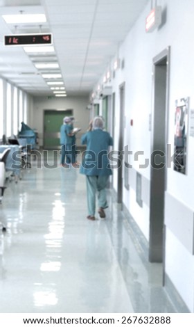 Blurred motion doctors and nurses walking in hospital corridor
