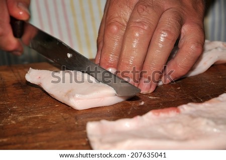 Cutting the pork fat for the greaves