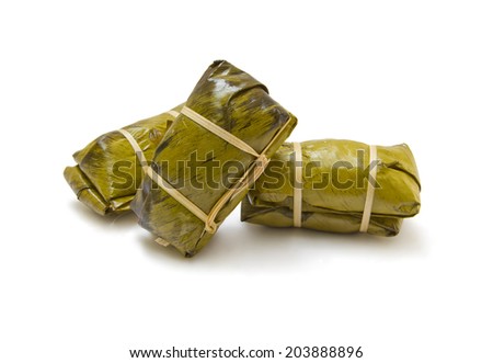 pile of glutinous rice steamed in banana leaf which is a Thai dessert made from sticky rice,banana,black bean and shredded coconut.