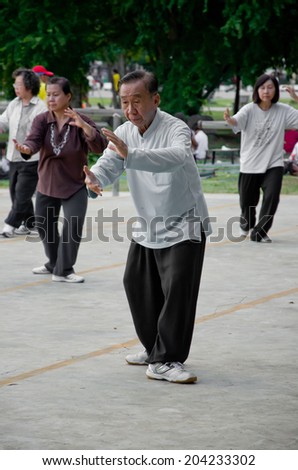 Nakhonsawan,Thailand,30 May 2012 : an old man play Taichi which is Chinese martial art.But in the present,people play this for good health.The photo taken at Sawan Park,Nakhonsawan,Thailand.