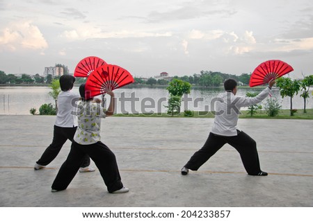 Nakhonsawan,Thailand,30 May 2012 : a group of people play Taichi Fan which is Chinese martial art at Sawan Park,Nakhonsawan,Thailand.