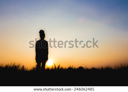silhouette of woman at sunset , Standing posture , near Dim atmosphere