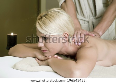 the girl at the spa, lying on the table wrapped in a towel and enjoy his body relaxing massage treatment / girl in spa center