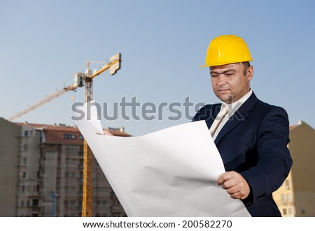 architect visits the construction site to see if building plans are going according to plan / architect