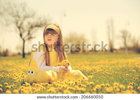 little girl enjoying the sunny spring day in fields flowers. vintage-look/little girl enjoying