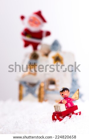 Christmas decoration with artificial snow, snow house, Santa Claus and angels in a sleigh/Christmas decoration