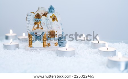 Christmas decoration with artificial snow, snow house and candles/Christmas and New Year decoration